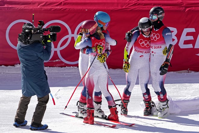 Team USA skaters River Radhamos, Michaela Shiffrin, Paula Moltzan and Tommy Ford comfort each other after losing their bronze medal match at the mixed tag team competition in the Alps.