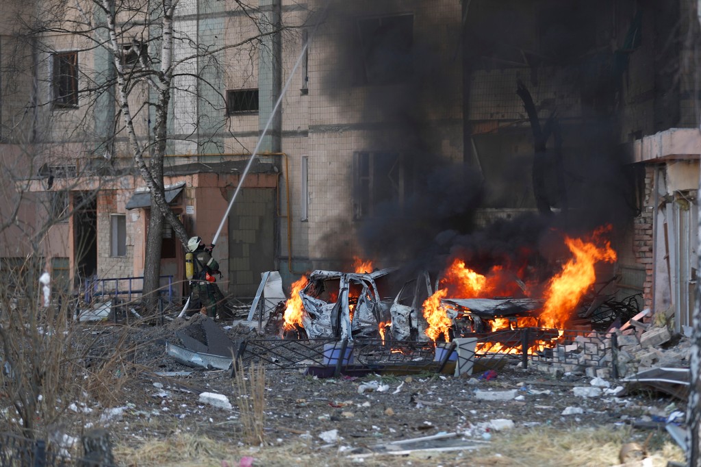 Ukrainian firefighters and security teams at the site of a Russian missile strike in Kyiv.