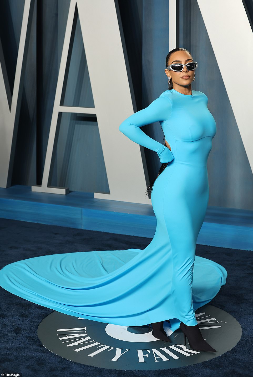 Breathtaking in blue!  Kim Kardashian put her iconic curves front and center as she mingled with Hollywood royalty at the 2022 Vanity Fair Oscar Party.