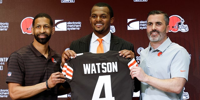 Cleveland Browns general manager Andrew Berry, left, new quarterback Deshaun Watson, center, and head coach Kevin Stefansky pose for a photo during a press conference at the NFL football team training facility, Friday, March 25, 2022, in Berea, Ohio. 