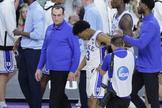 Mike Krzyzewski leaves court after Saturday's loss to UNC.