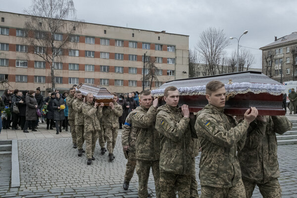 Ukrainian soldiers at a military funeral for their fallen comrades on Wednesday in Lviv.