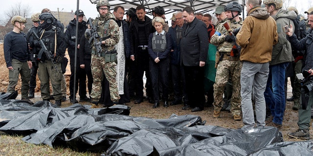 European Commission President Ursula von der Leyen, EU High Representative for Foreign Affairs and Security Policy Josep Borrell, Slovakian Prime Minister Eduard Heger and Ukrainian Prime Minister Denis Shmyal stand next to a mass grave while they visit the town of Bucha, as Russia.  The attack on Ukraine continues, outside of Kyiv, Ukraine on April 8, 2022. 