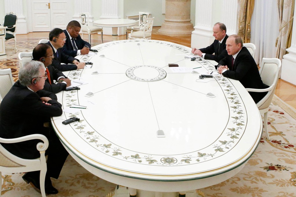 Russian President Vladimir Putin (right, front), accompanied by Security Council Secretary Nikolai Patrushev (right, back), attends a meeting with top BRICS officials. 