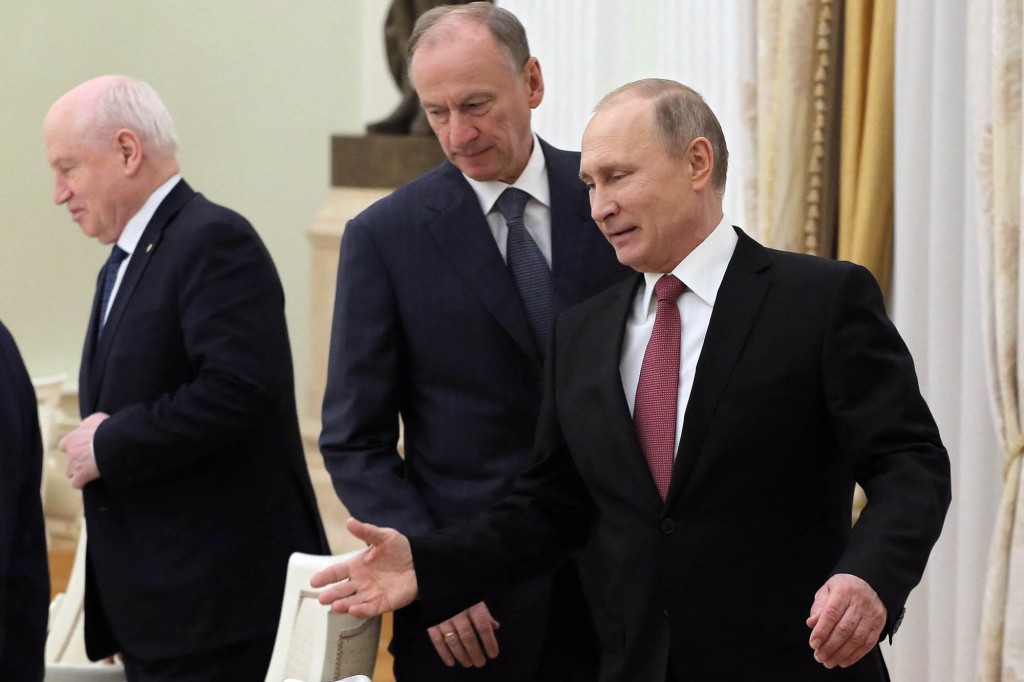 Russian President Vladimir Putin (R) and then-Secretary of the Russian Security Council Nikolai Patrushev (C) arrive for a meeting with the heads of security and intelligence in 2017.