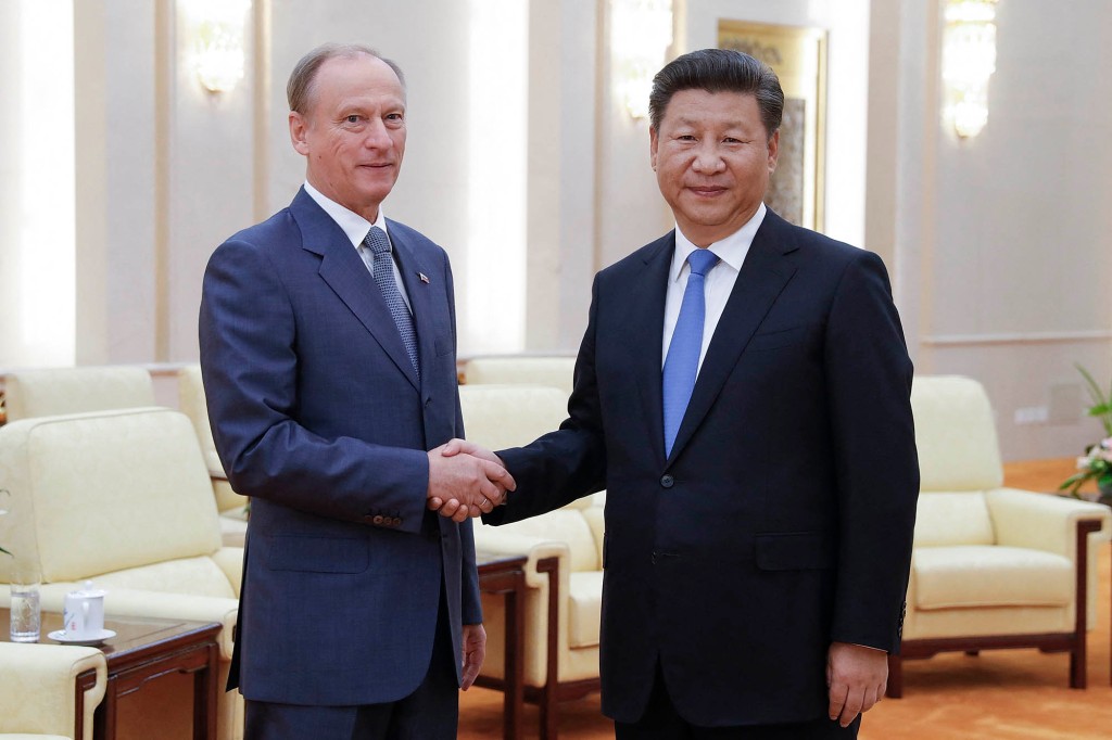 Chinese President Xi Jinping (right) shakes hands with Russian Security Council Secretary Nikolai Patrushev at the Great Hall of the People in Beijing, September 14, 2016.