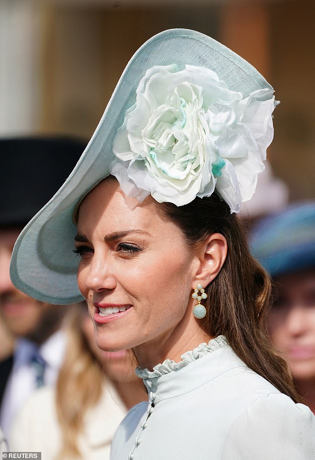 Kate Middleton was pictured wearing a £140 pair of aquamarine drop earrings at a garden party at Buckingham Palace yesterday (pictured)