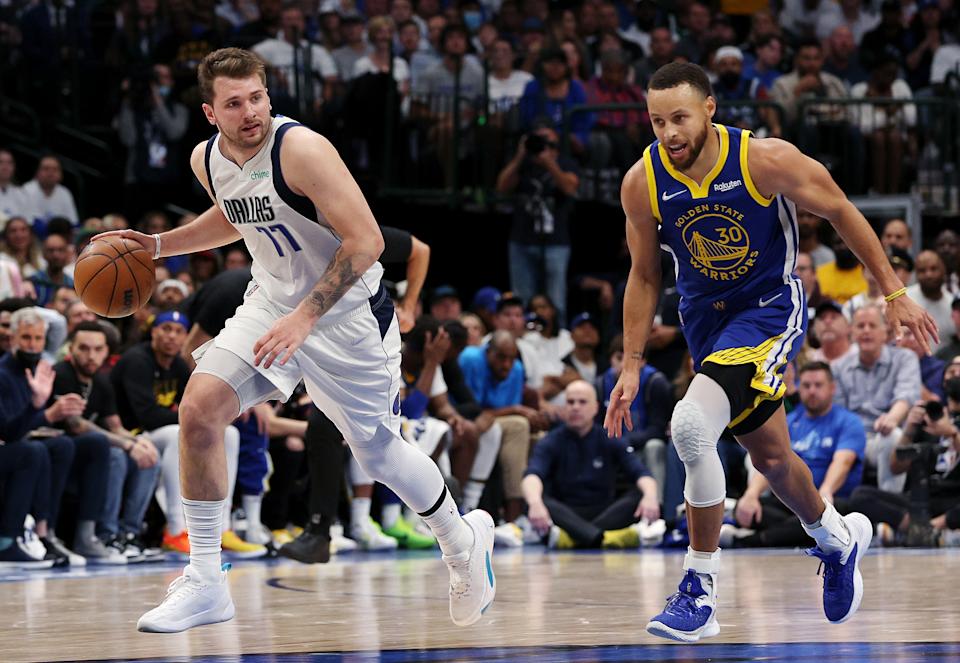 Dallas Mavericks Luka Doncic guards the ball on the court against Golden State Warriors guard Stephen Curry in Game 4 of the Western Conference Finals at American Airlines Center in Dallas on May 24, 2022 (Tom Pennington/Getty Images)