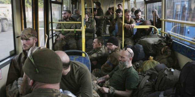 Ukrainian soldiers sit on a bus after being evacuated from the besieged Azovstal steel plant in Mariupol on Tuesday, May 17. 
