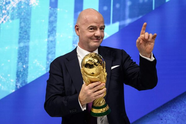 FIFA's president, Gianni Infantino, with soccer's biggest prize, the World Cup trophy.