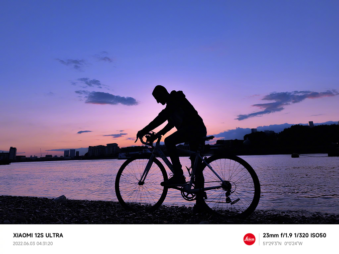 Sample shot taken with a Xiaomi 12S Ultra, showing a cyclist on a river bank in the early morning before sunrise.