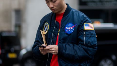 A guest wears a NASA bomber jacket during the men's collections at London Fashion Week at Matthew Miller on January 7, 2017 in London, England.