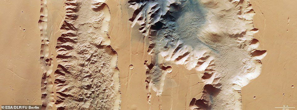 The huge valley of the red planet has been revealed in new images released by the European Space Agency.  The new image depicts two trenches, or chasma, that form part of the western part of Valles Marineris.  On the left is the 521-mile Lus Chasma Trail and on the right is the 500-mile Tithonium Chasma Trail