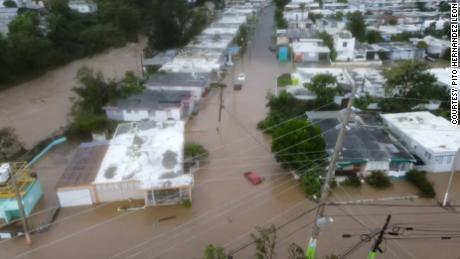 Cars and homes are under water in Puerto Rico, which is still left behind without electricity.