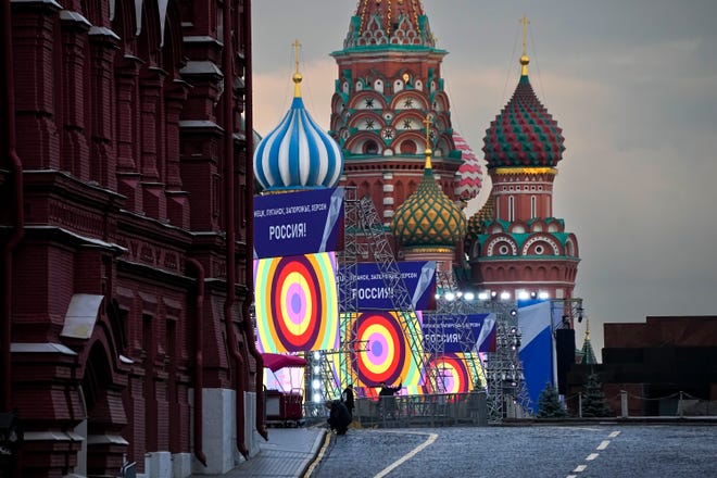 People are preparing for a concert in Red Square, where the installations read the phrase 