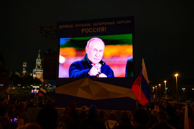 Russian President Vladimir Putin appears on a screen while addressing a crowd and a concert marking the annexation of four regions of Ukraine occupied by Russian forces - Lugansk, Donetsk, Kherson and Zaporizhia, in central Moscow on September 30, 2022.