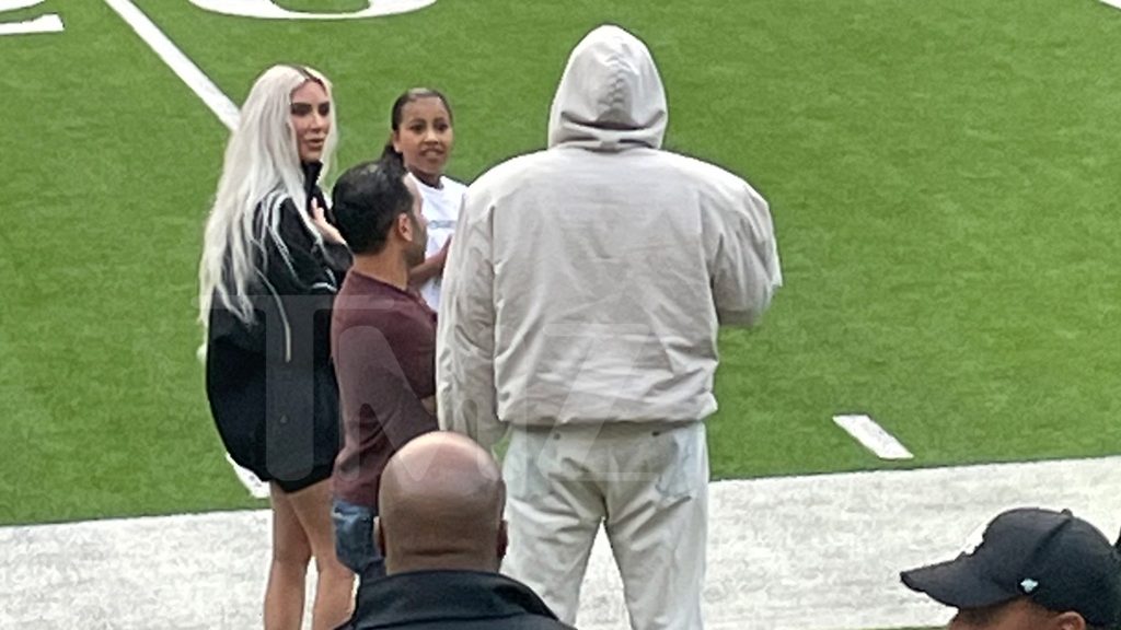 Kim Kardashian and Kanye West attend a soccer game at Saint, chatting on the sidelines