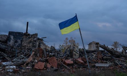 A Ukrainian flag flies over the ruins of buildings destroyed during the fighting between the Ukrainian and Russian occupation forces in Kamyanka, Kharkiv region.