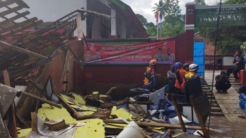 Workers inspect an earthquake-damaged school in Cianjur, West Java.