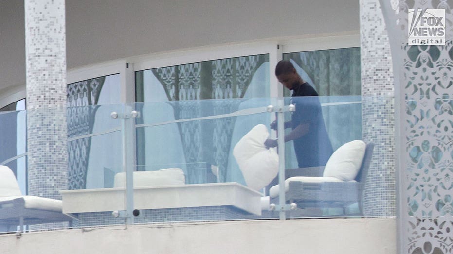 A man prepares the balcony of Sam Bankman-Fried's penthouse
