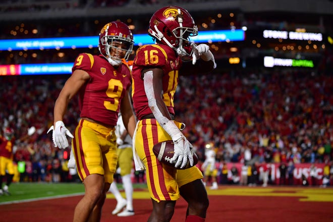 Southern California wide receiver Tahaj Washington (16) celebrates his touchdown during halftime against Notre Dame at Los Angeles Memorial Coliseum.