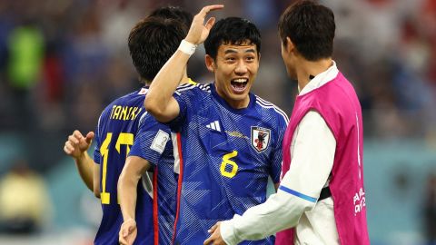 Wataru Endo celebrates with his teammates after Japan qualified for the knockout stages of the World Cup. 