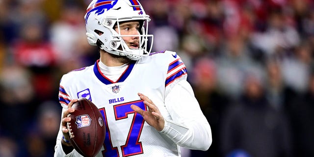 17 Buffalo Bills quarterback Josh Allen runs down again for a pass in the first quarter against the New England Patriots at Gillette Stadium on December 1, 2022 in Foxboro, Massachusetts. 