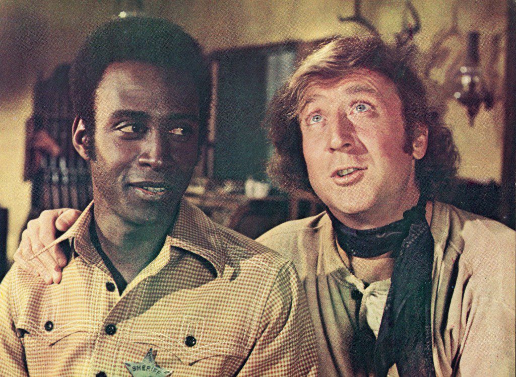 Gene Wilder (right) puts his arm around Cleavon Little's shoulder in a still from the movie, "blazing saddles," Directed by Mel Brooks, 1974.