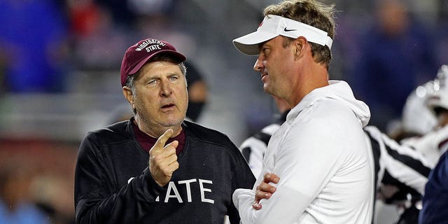 Mississippi State Bulldogs head coach Mike Leach and Mississippi Rebels head coach Lane Kiffin speak before the game at Fout Hemingway Stadium on November 24, 2022 in Oxford, Mississippi.