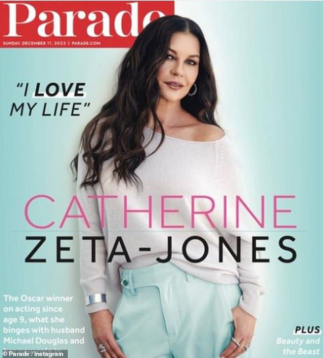 Still gorgeous: Catherine Zeta-Jones unveiled her new cover of Parade in a chic off-the-shoulder jacket and turquoise pants